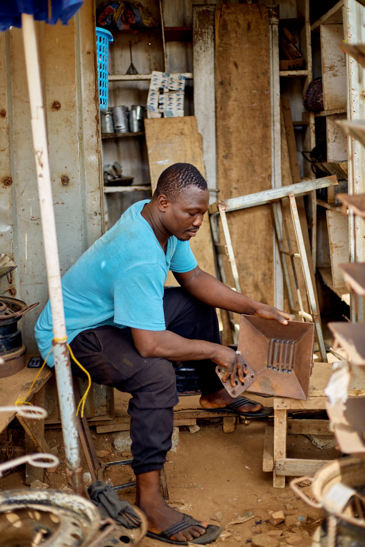 A craftsman working with metal in an Accra workshop