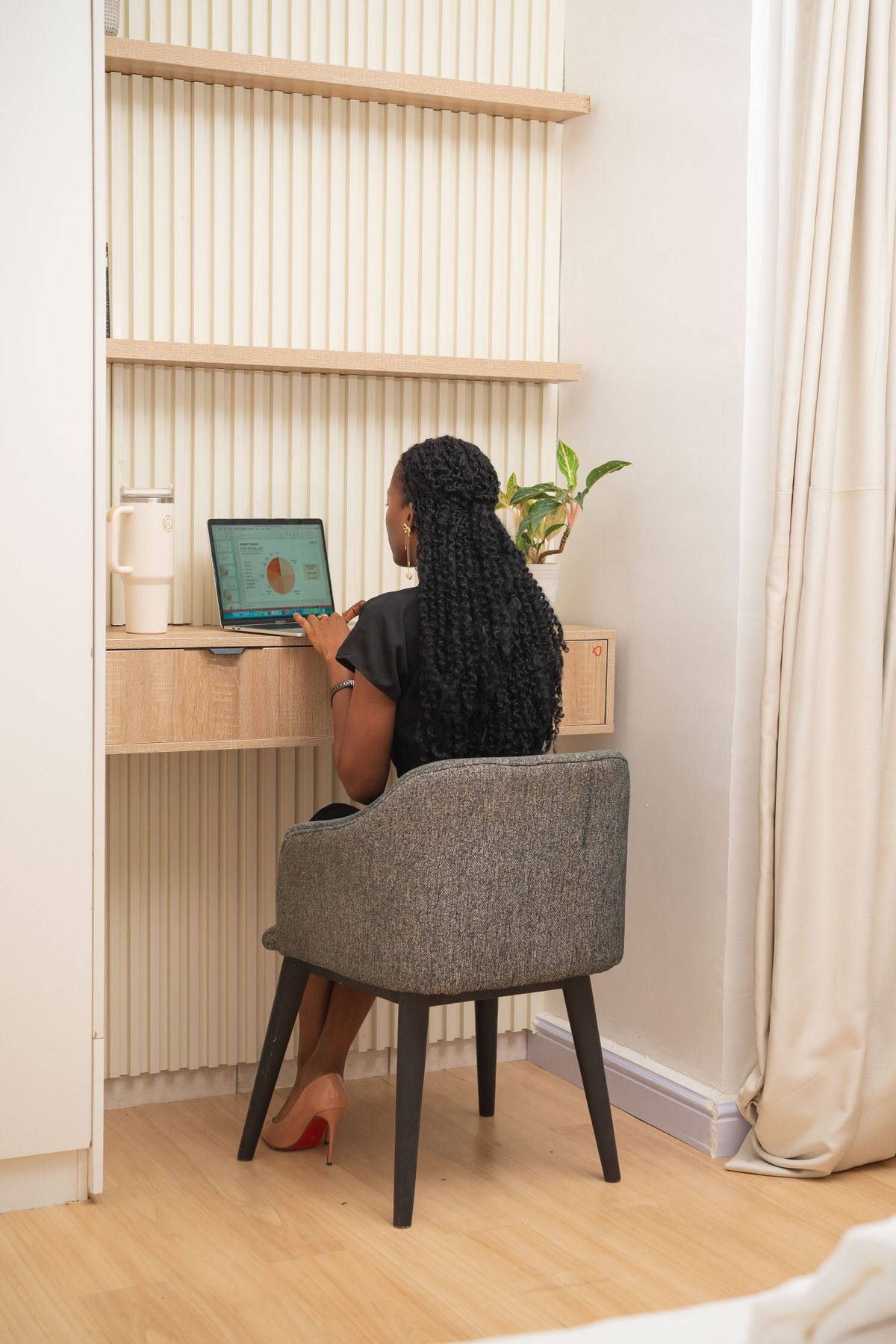 A woman working at her home-office desk in Abuja