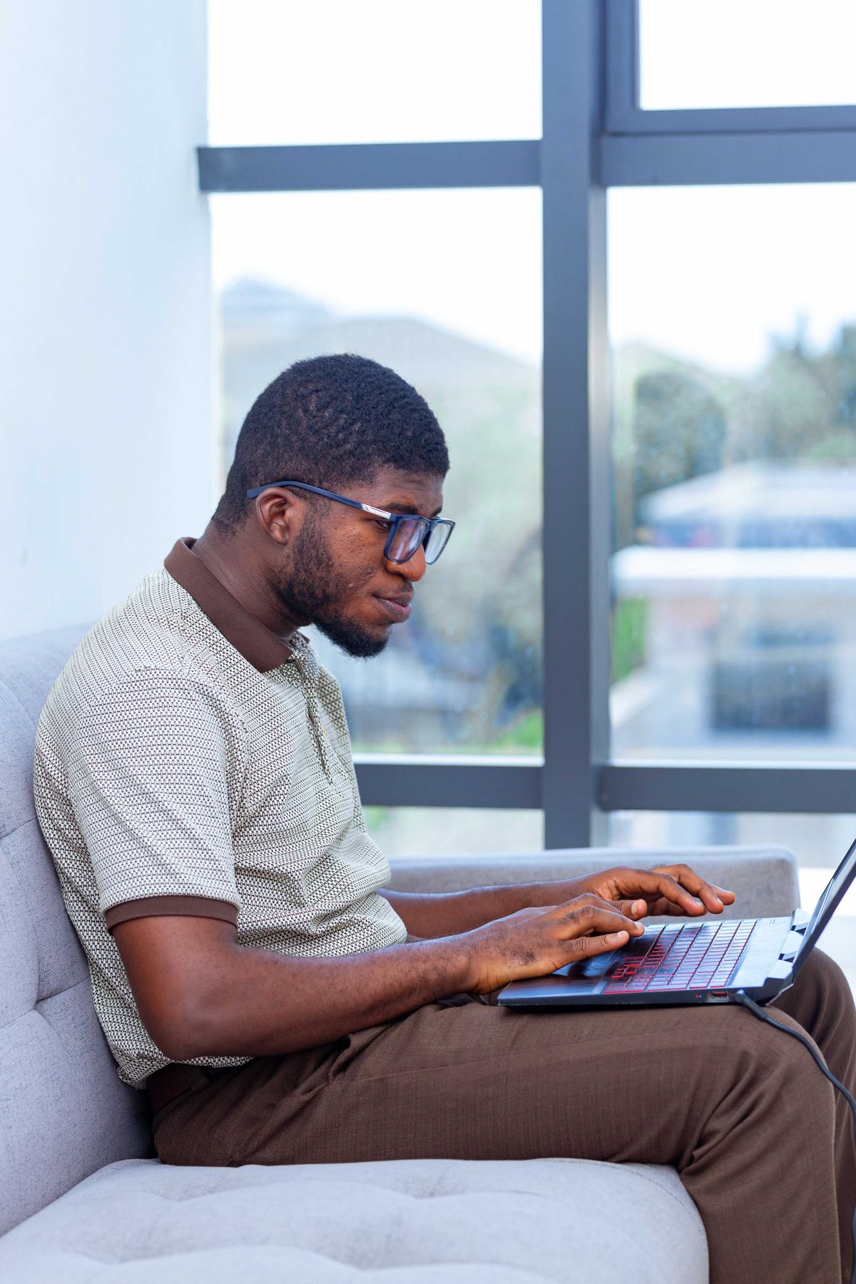 A professional working on a laptop in Accra