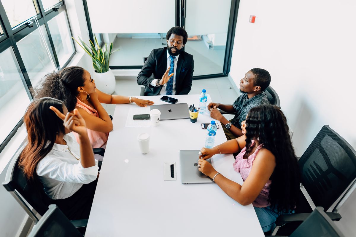 Professionals discussing work around a table in a Lagos office