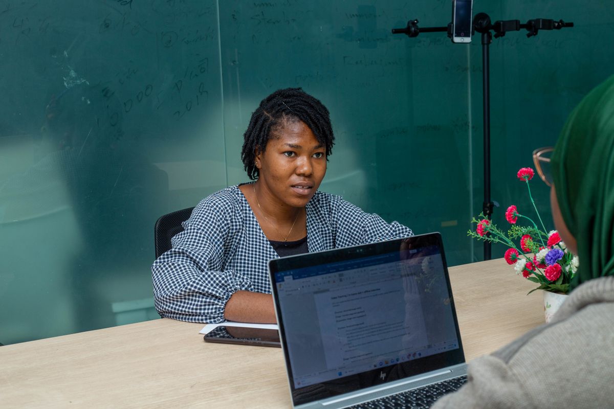 Colleagues working together with laptops in a Lagos office